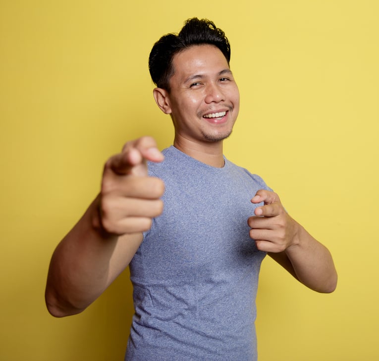 Casual Young Man Pointing the Camera Very Happy